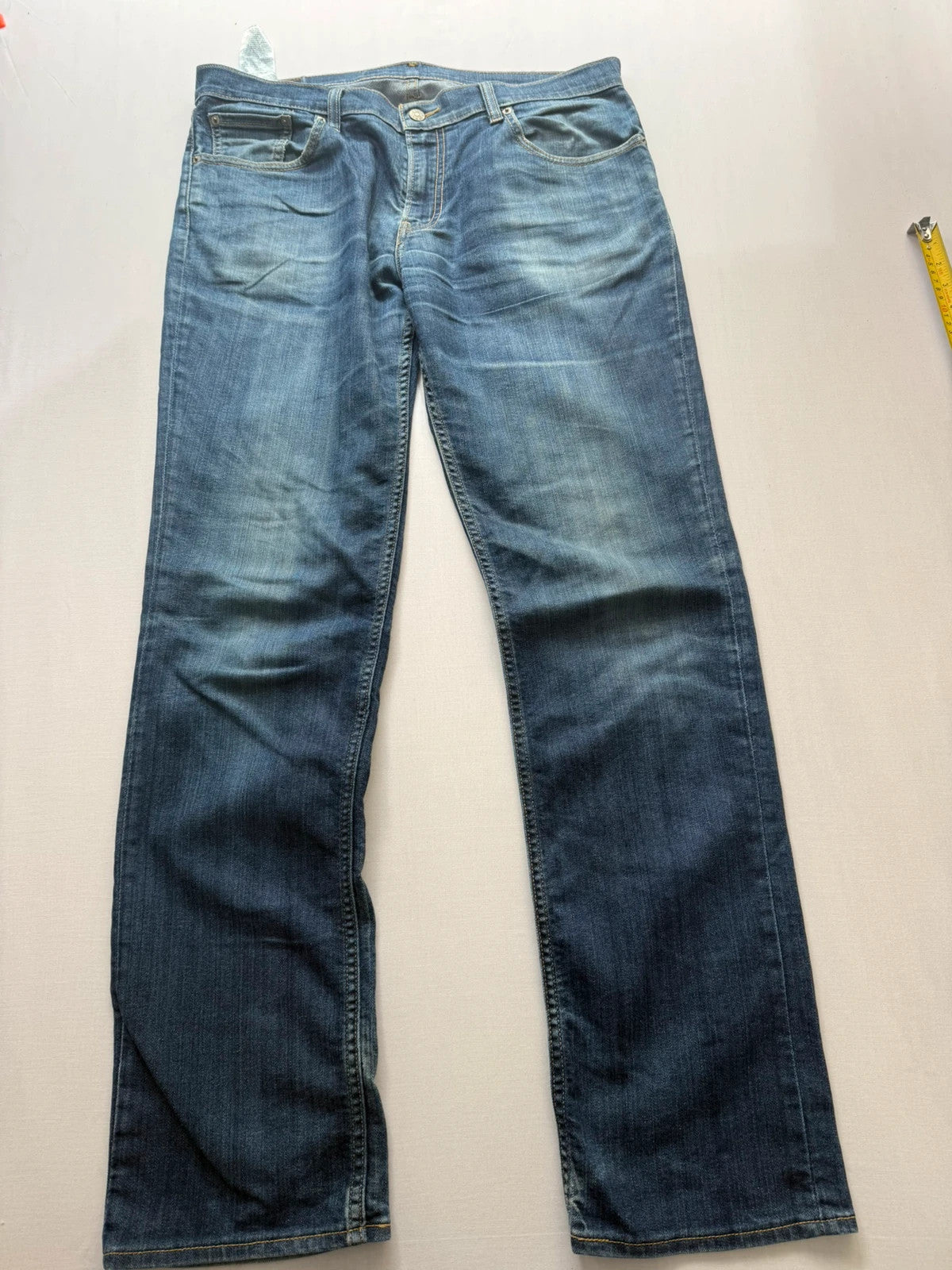 Levi's blue straight jeans with classic 5-pocket styling and signature back stitching.