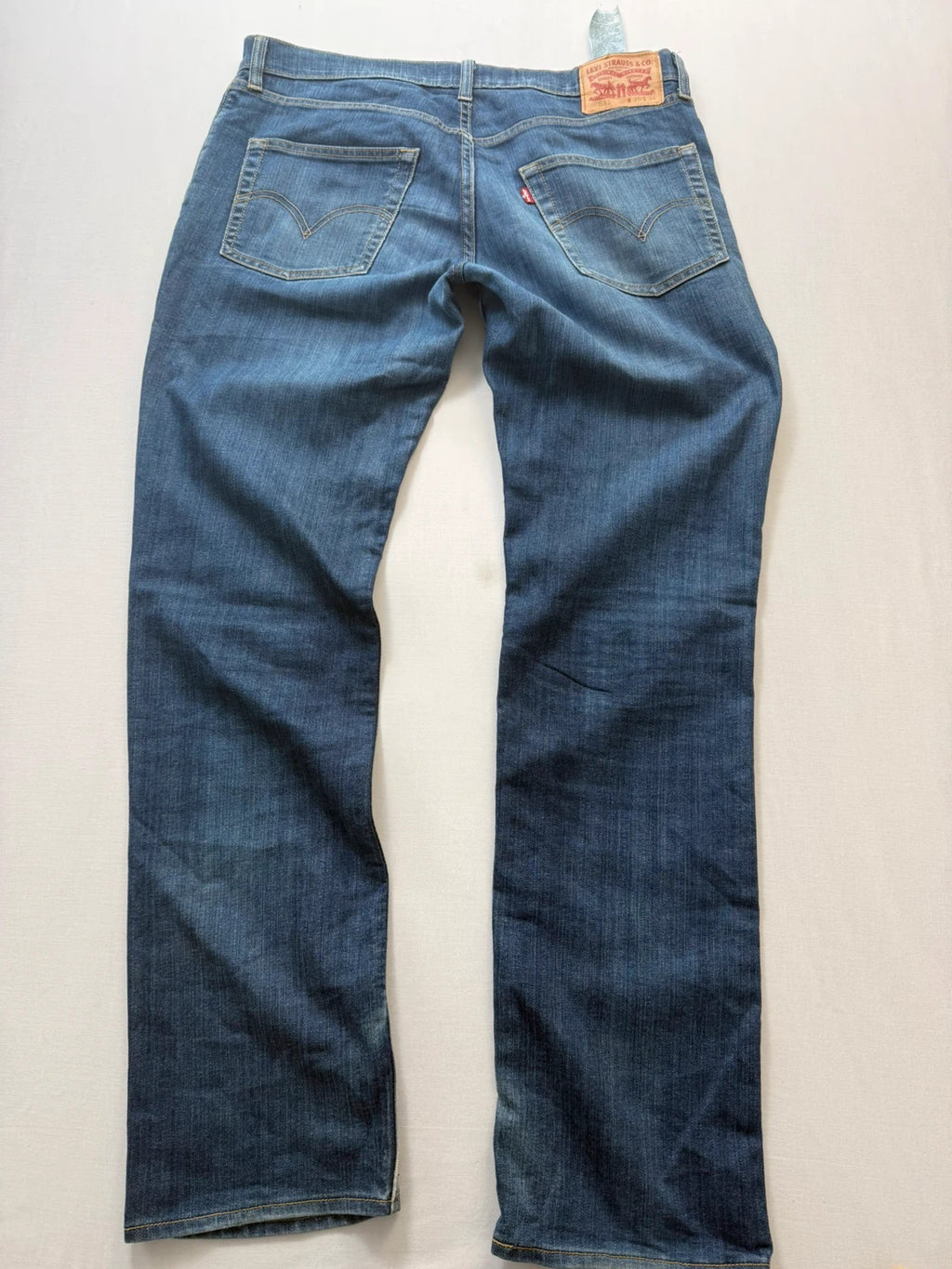 Levi's blue straight jeans with classic 5-pocket styling and signature back stitching.