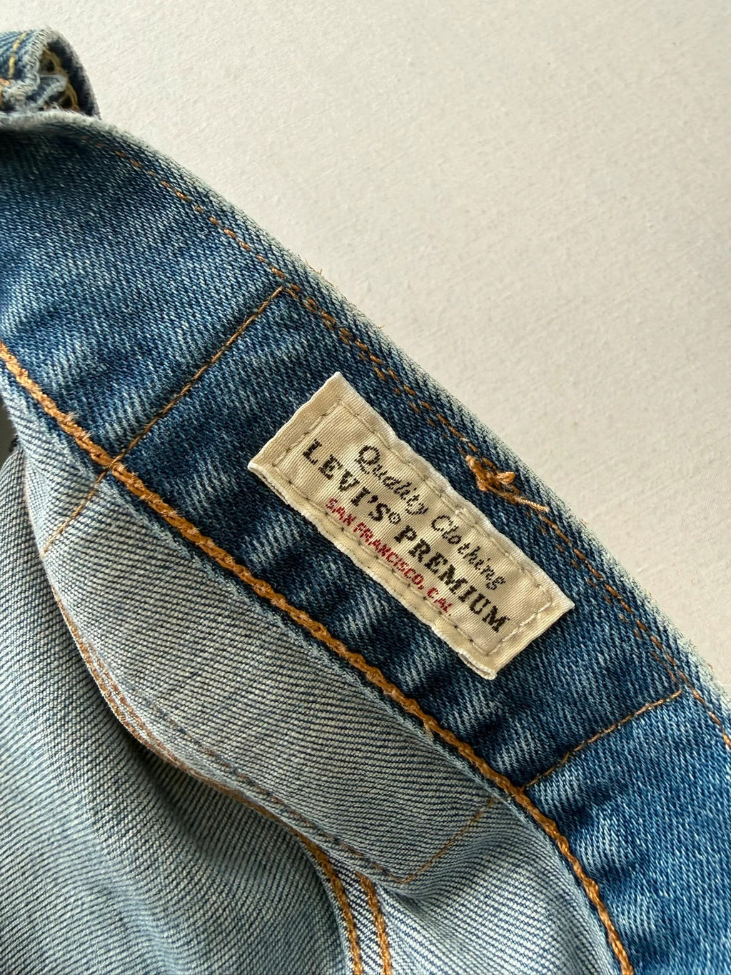 Levi's blue straight jeans with natural fading, 5-pocket styling, and back arcuate stitching.