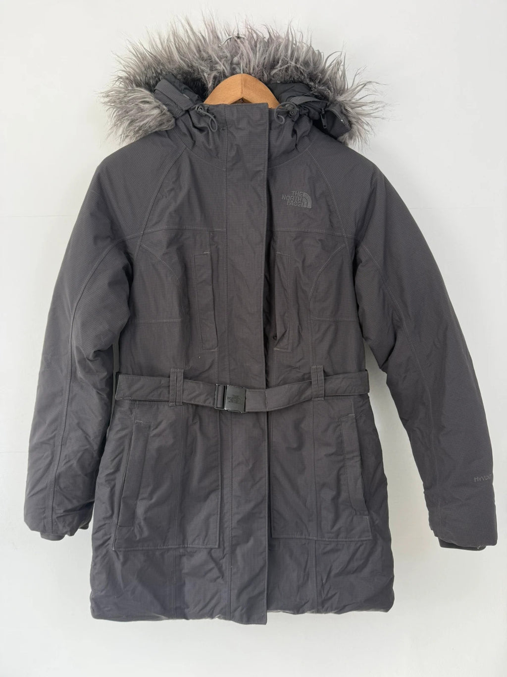 The North Face grey down parka with detachable faux fur hood and multiple pockets.