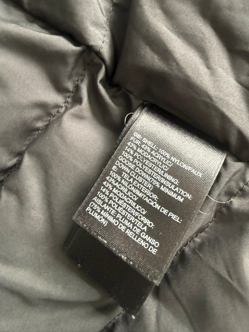 The North Face grey down parka with detachable faux fur hood and multiple pockets.