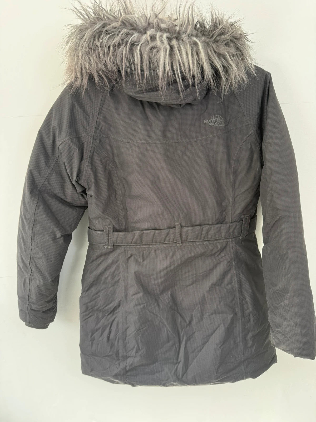 The North Face grey down parka with detachable faux fur hood and multiple pockets.