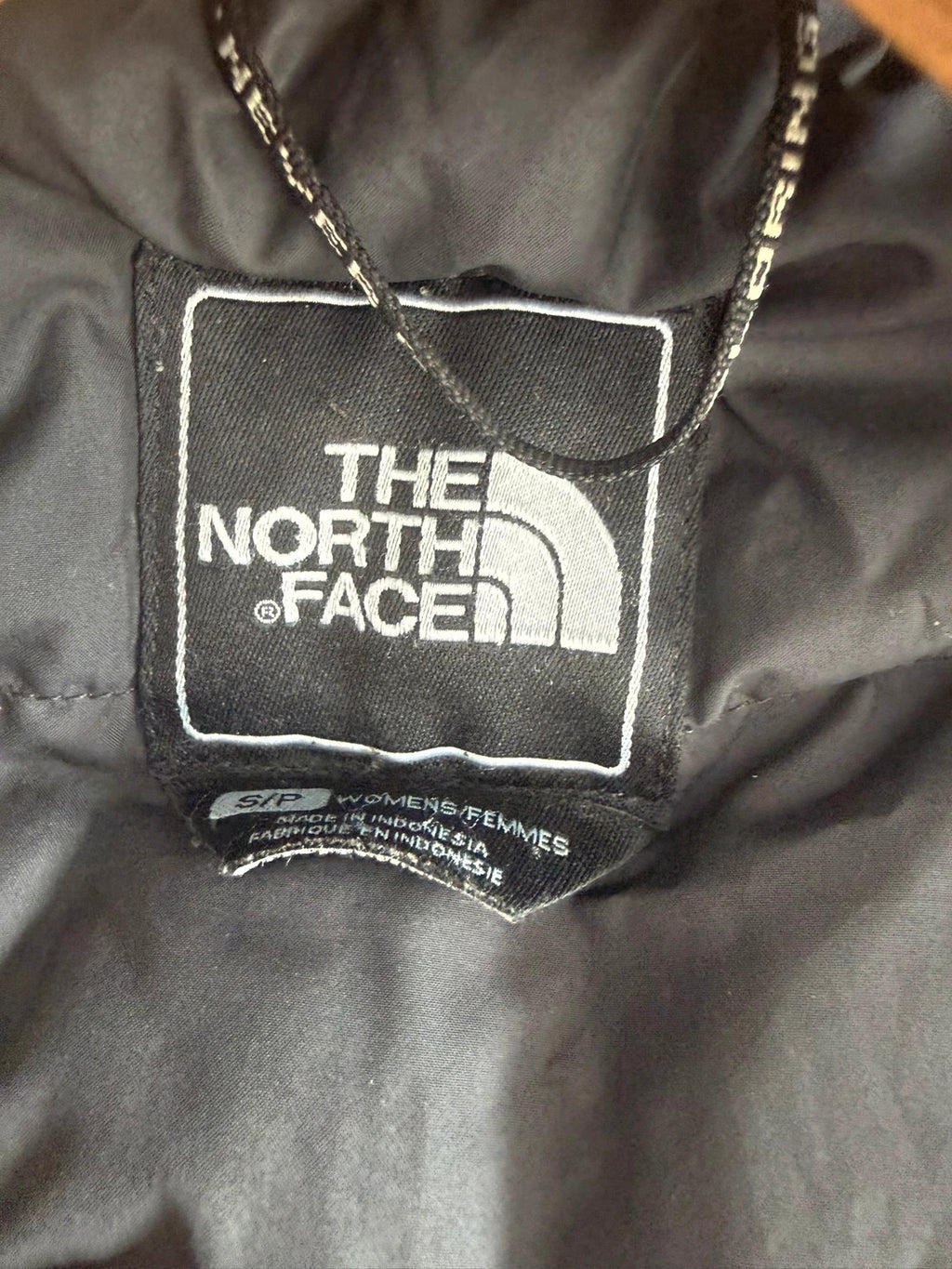 The North Face grey down parka with detachable faux fur hood and multiple pockets.