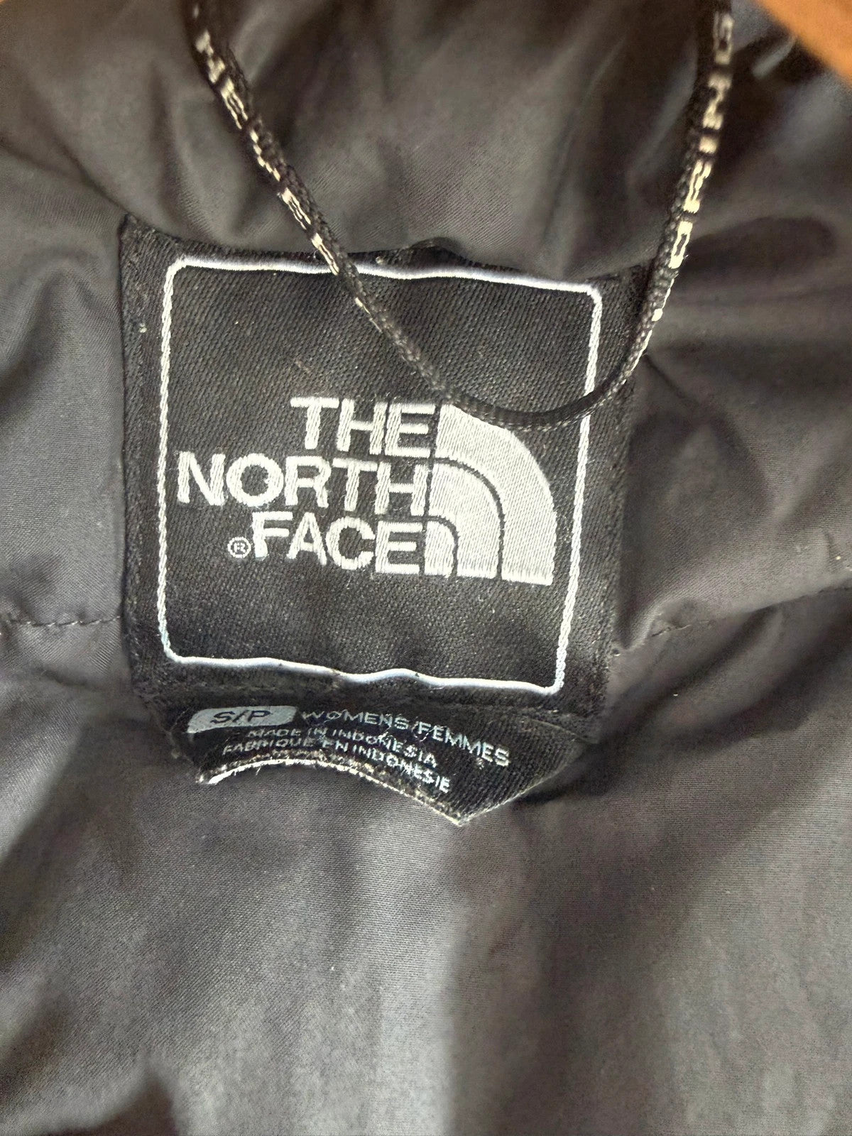 The North Face grey down parka with detachable faux fur hood and multiple pockets.