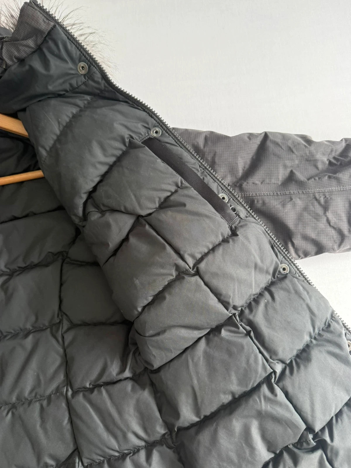 The North Face grey down parka with detachable faux fur hood and multiple pockets.