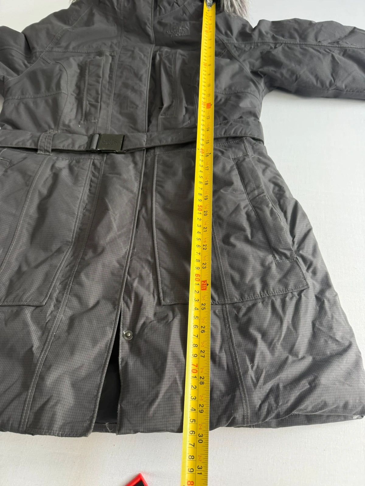 The North Face grey down parka with detachable faux fur hood and multiple pockets.