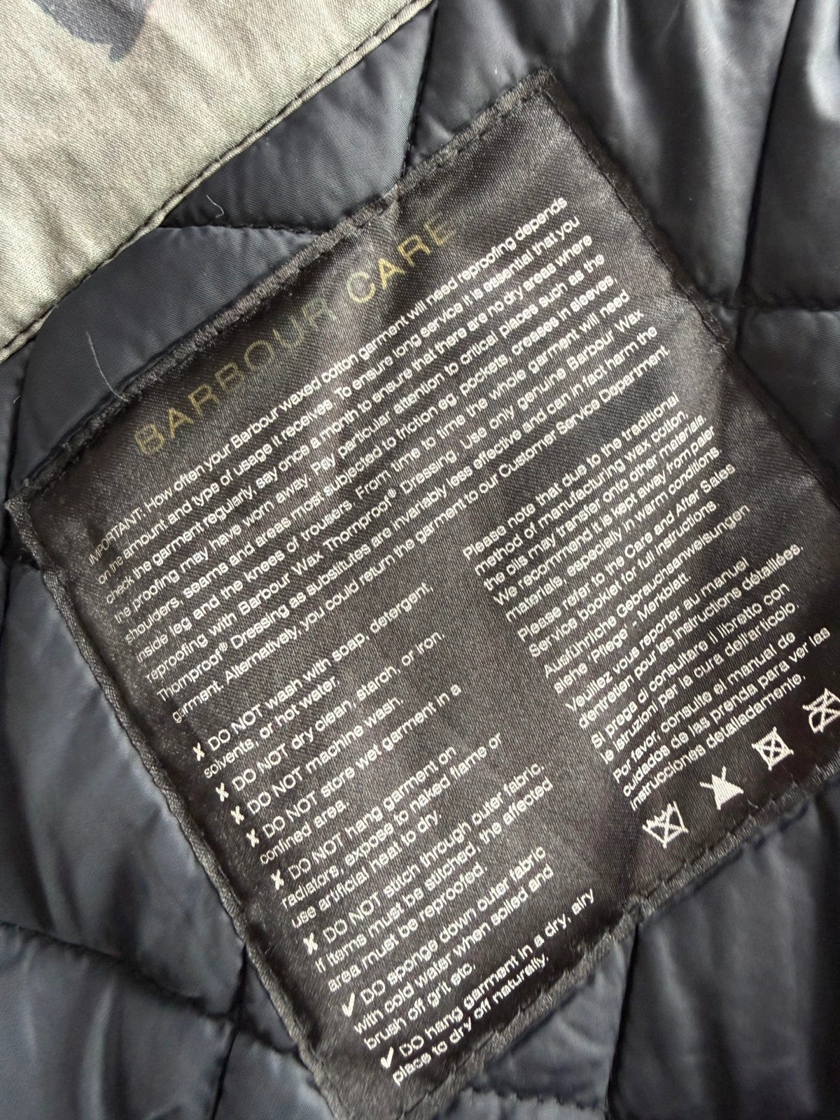 Barbour black waxed cotton biker jacket with embroidered Team Barbour patch and American flag lining.