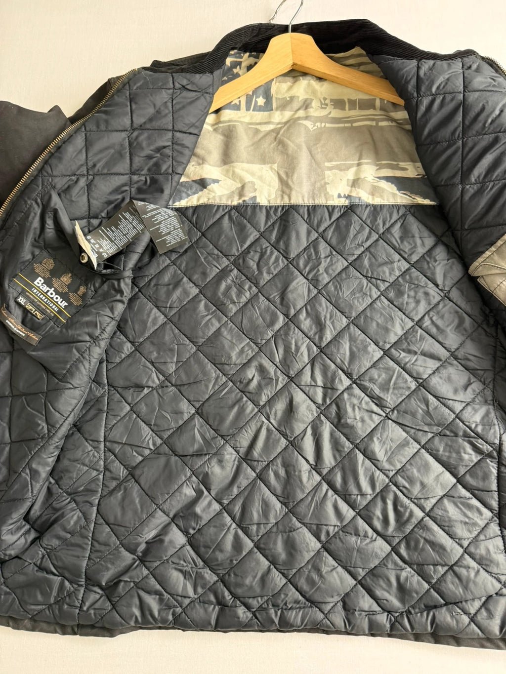 Barbour black waxed cotton biker jacket with embroidered Team Barbour patch and American flag lining.