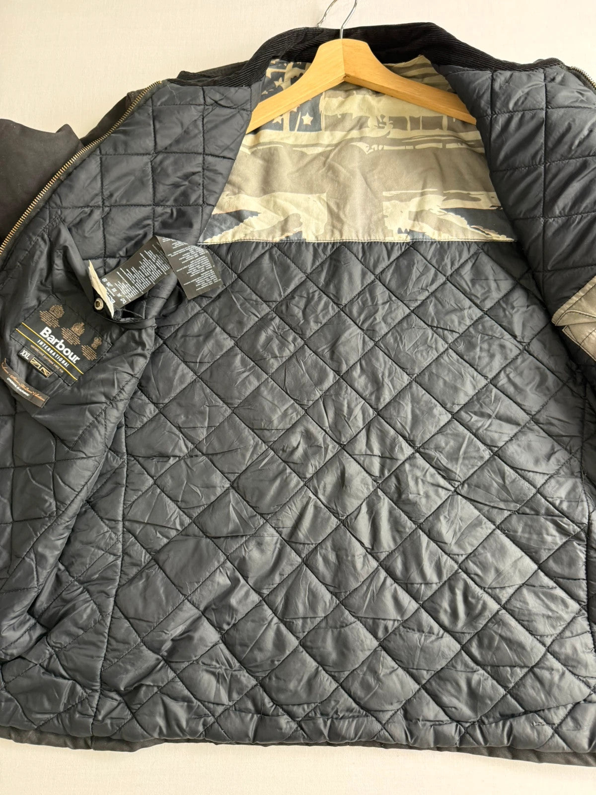 Barbour black waxed cotton biker jacket with embroidered Team Barbour patch and American flag lining.