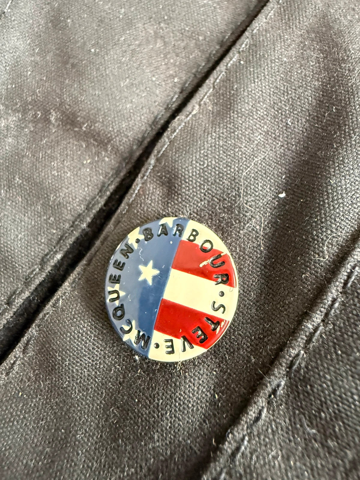 Barbour black waxed cotton biker jacket with embroidered Team Barbour patch and American flag lining.