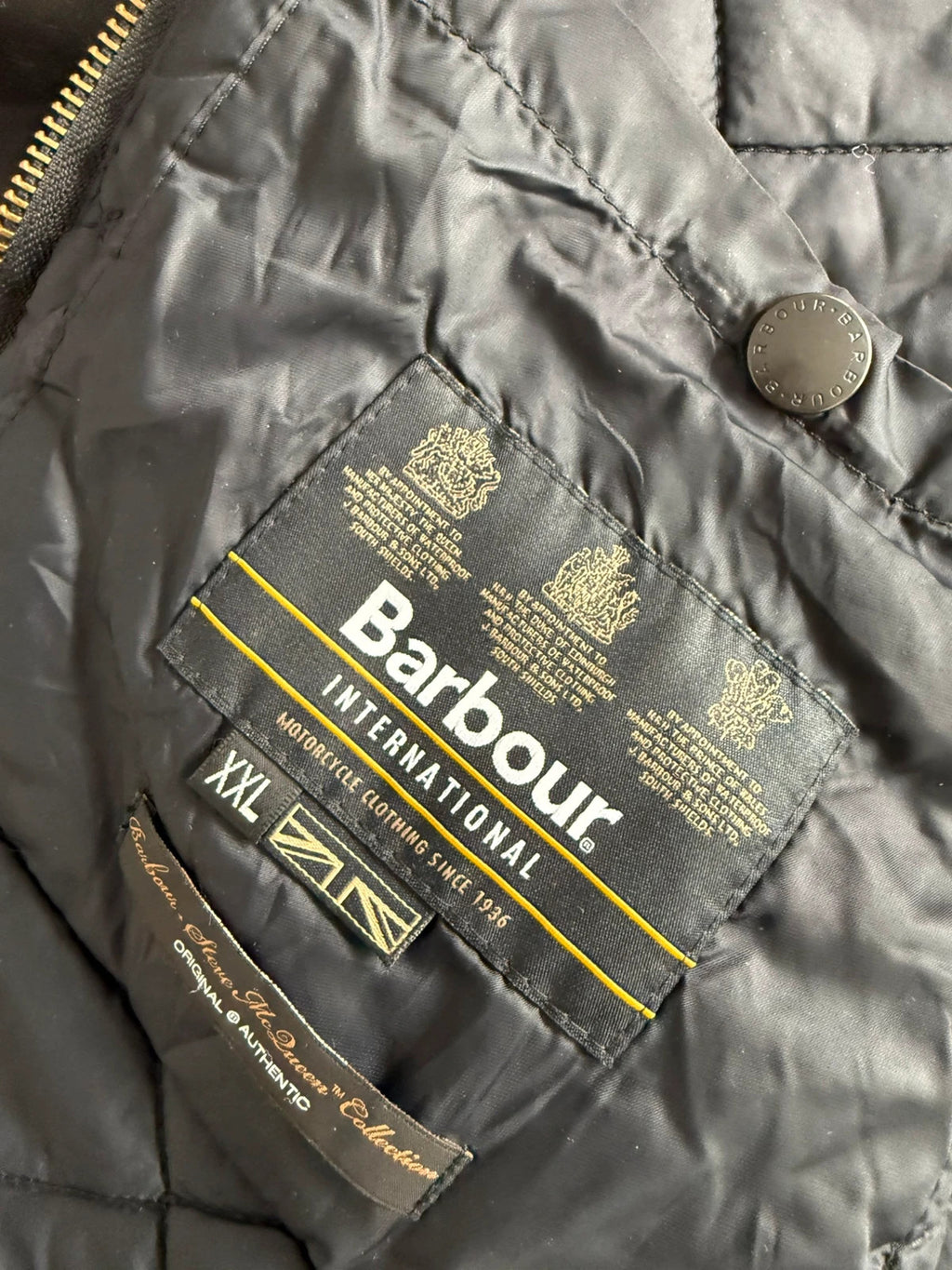 Barbour black waxed cotton biker jacket with embroidered Team Barbour patch and American flag lining.
