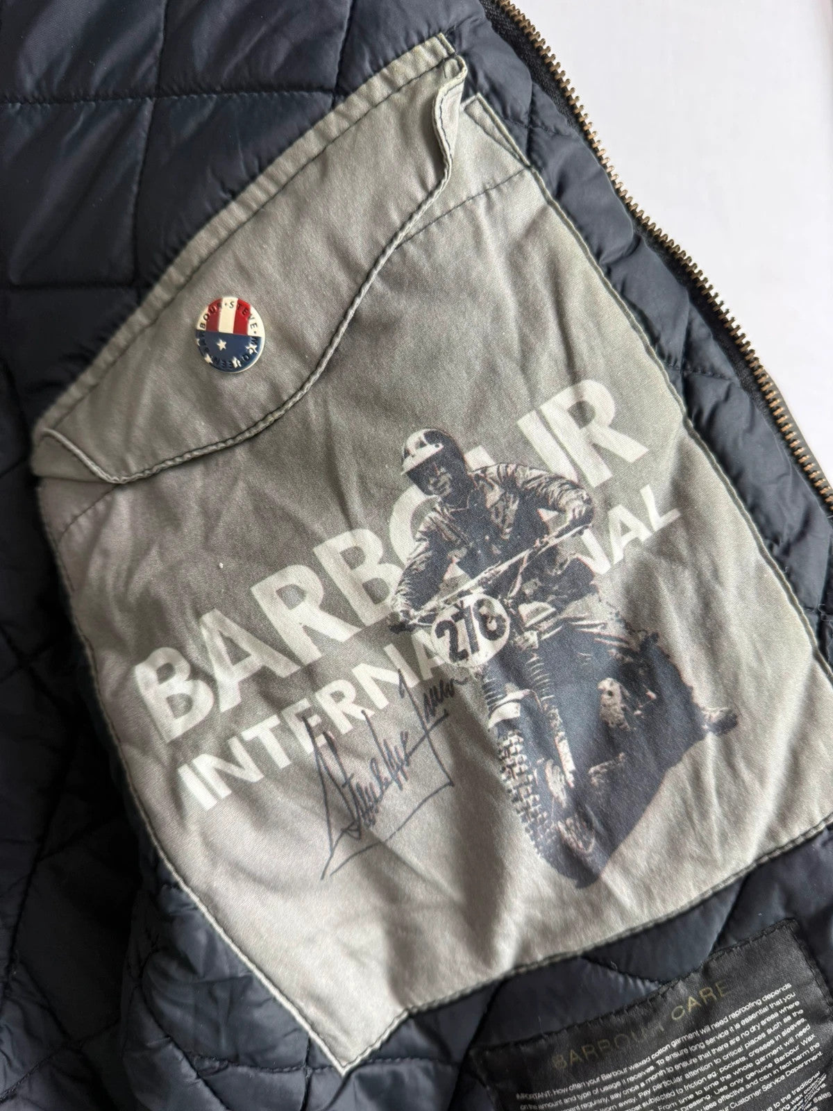Barbour black waxed cotton biker jacket with embroidered Team Barbour patch and American flag lining.