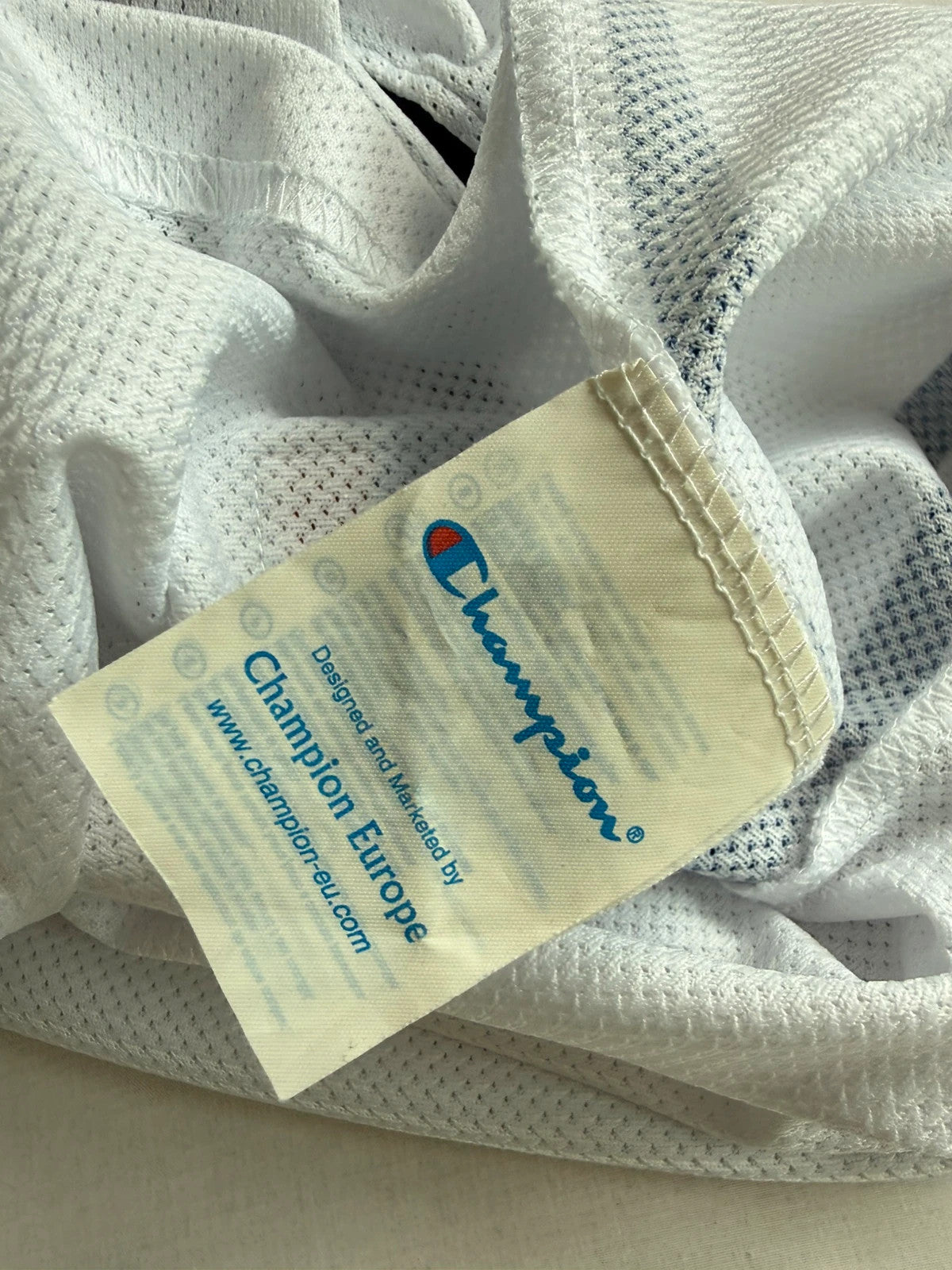 Champion graphic tee blue and white, embroidered NBA logo, mesh fabric, sleeveless cut.