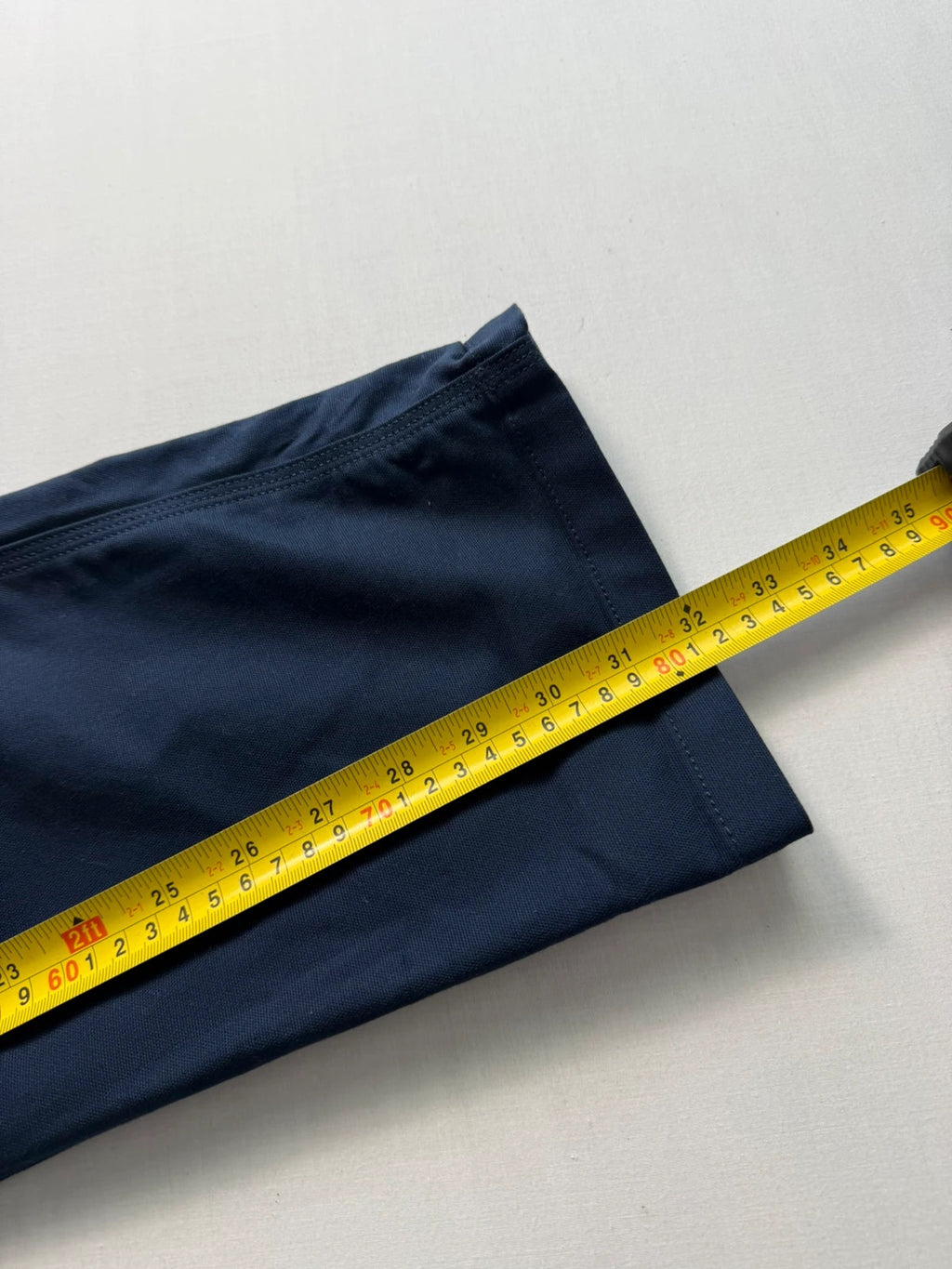 Carhartt navy work trousers with reinforced knees, multiple pockets, and Rugged Flex stretch.