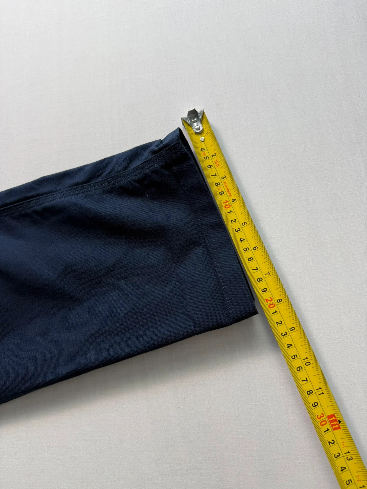 Carhartt navy work trousers with reinforced knees, multiple pockets, and Rugged Flex stretch.