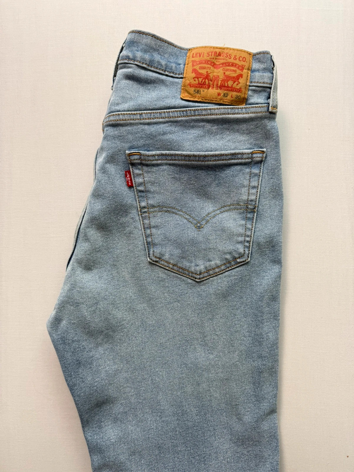 Levi's blue straight jeans light wash stretch denim with signature back-pocket arcuate stitching.