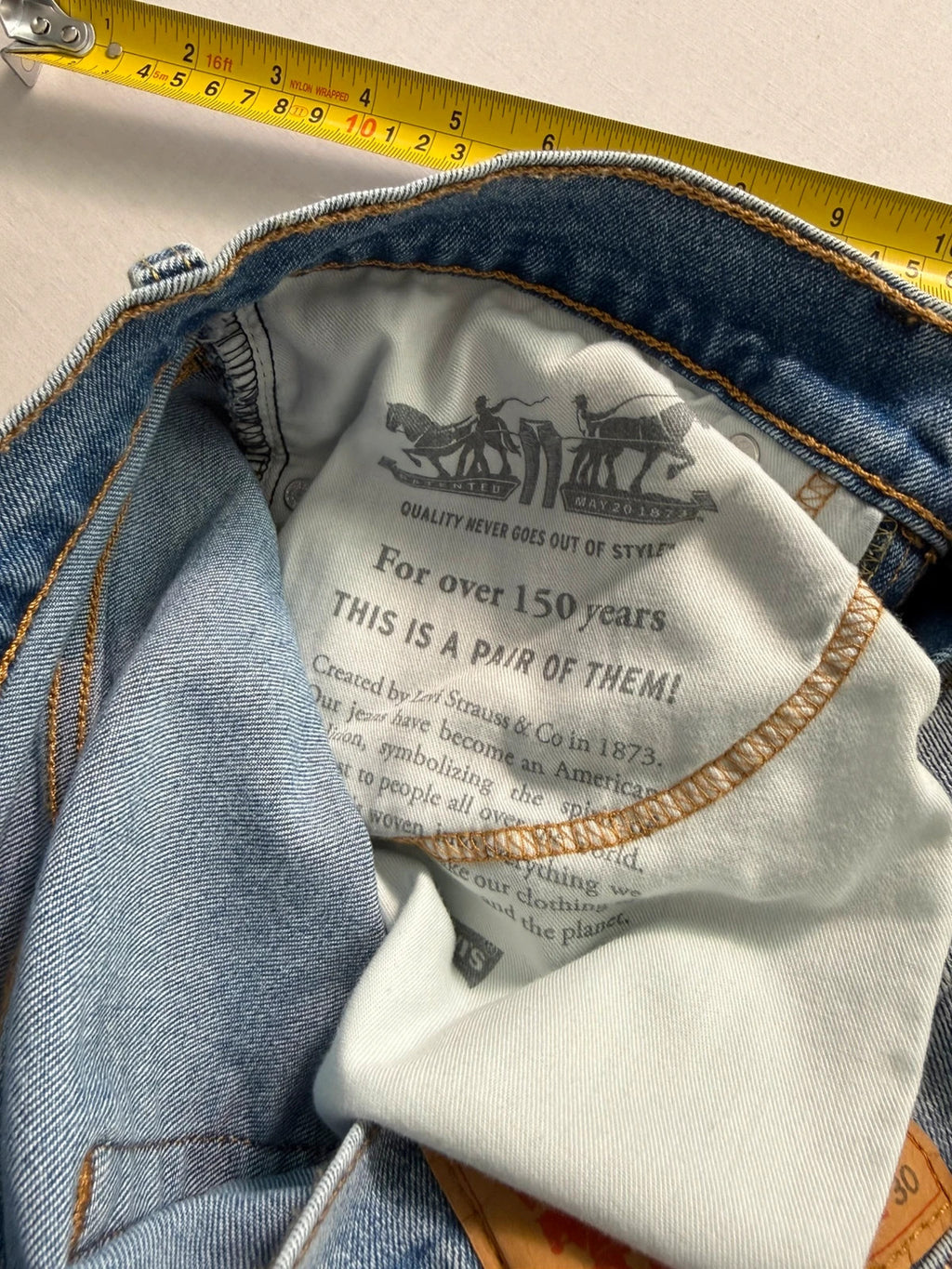 Levi's blue straight jeans light wash stretch denim with signature back-pocket arcuate stitching.