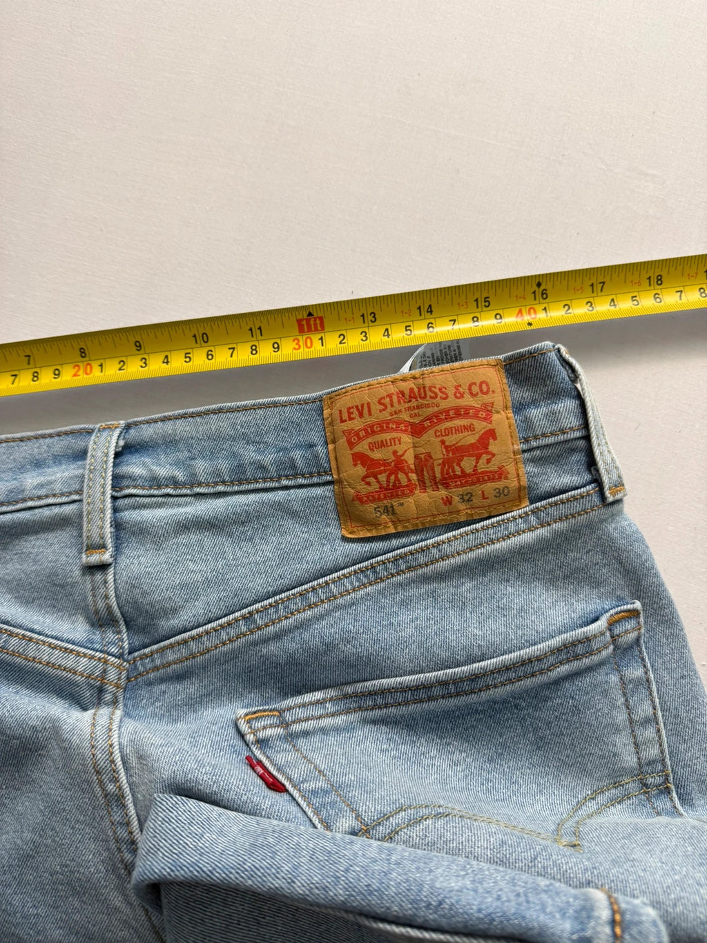 Levi's blue straight jeans light wash stretch denim with signature back-pocket arcuate stitching.