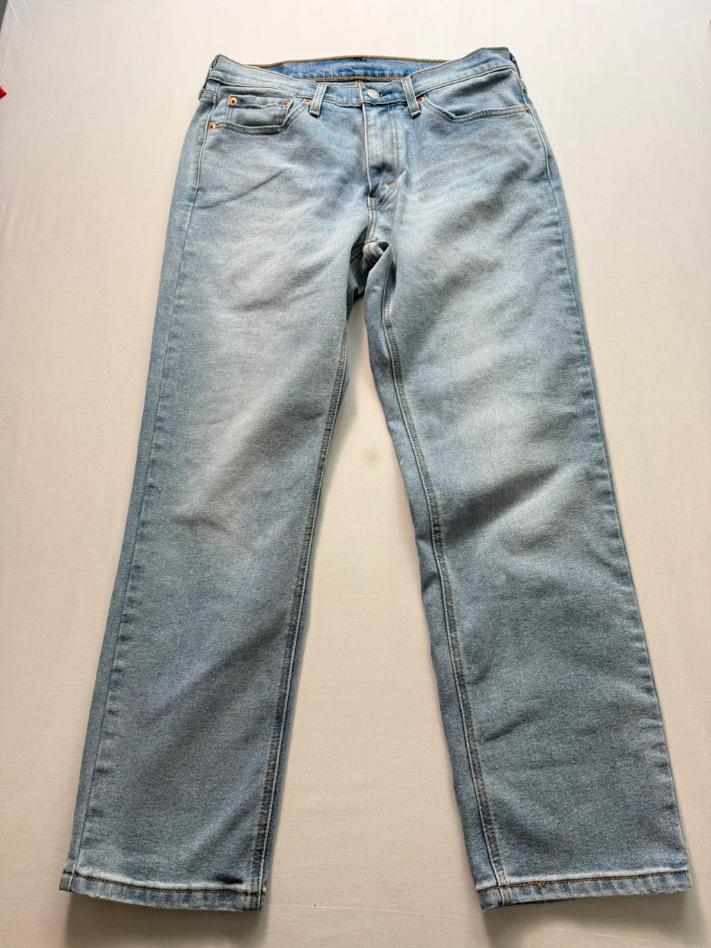 Levi's blue straight jeans light wash stretch denim with signature back-pocket arcuate stitching.