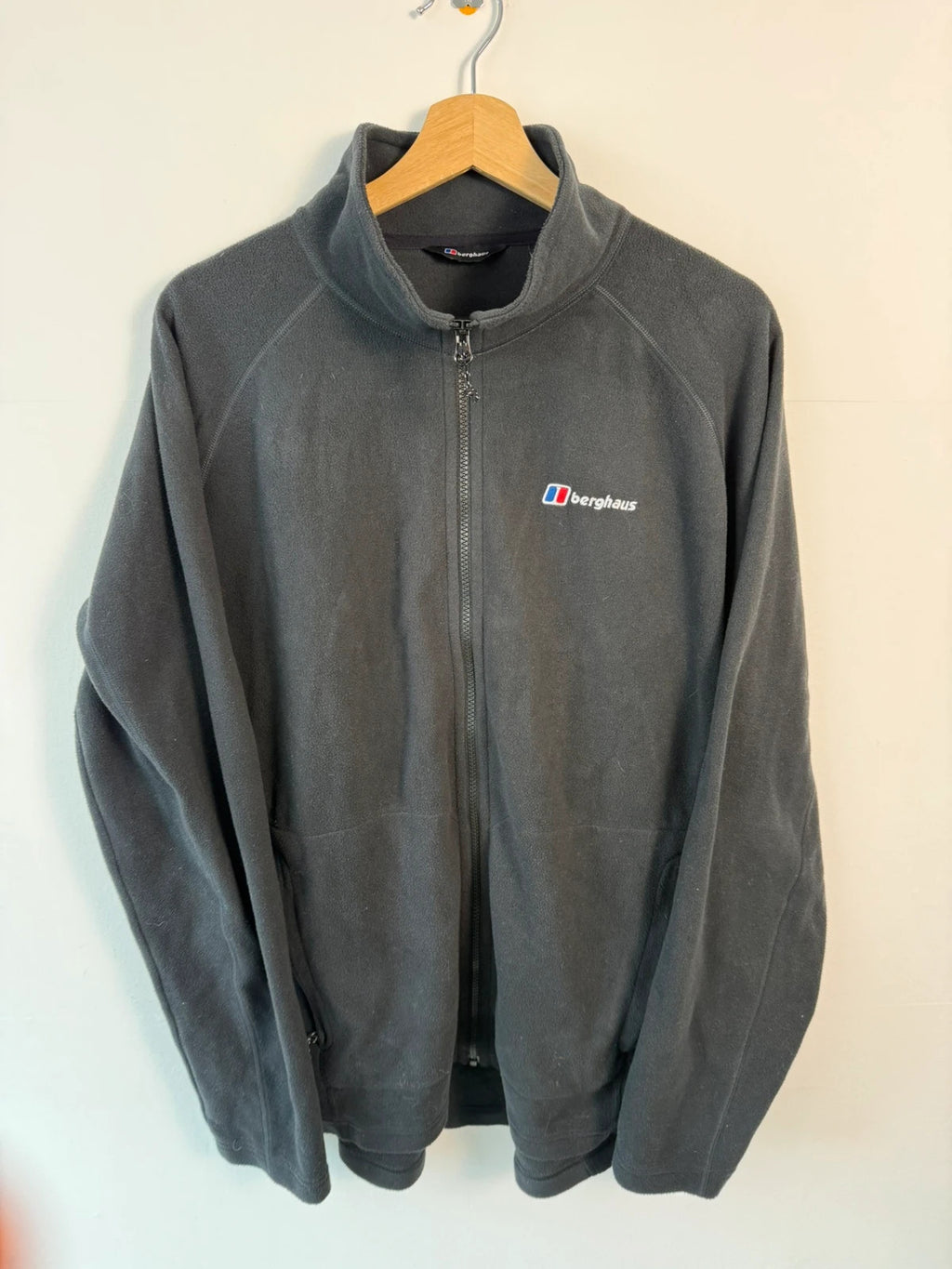 Berghaus grey fleece jacket with stand-up collar and zipped pockets, lightweight polyester.