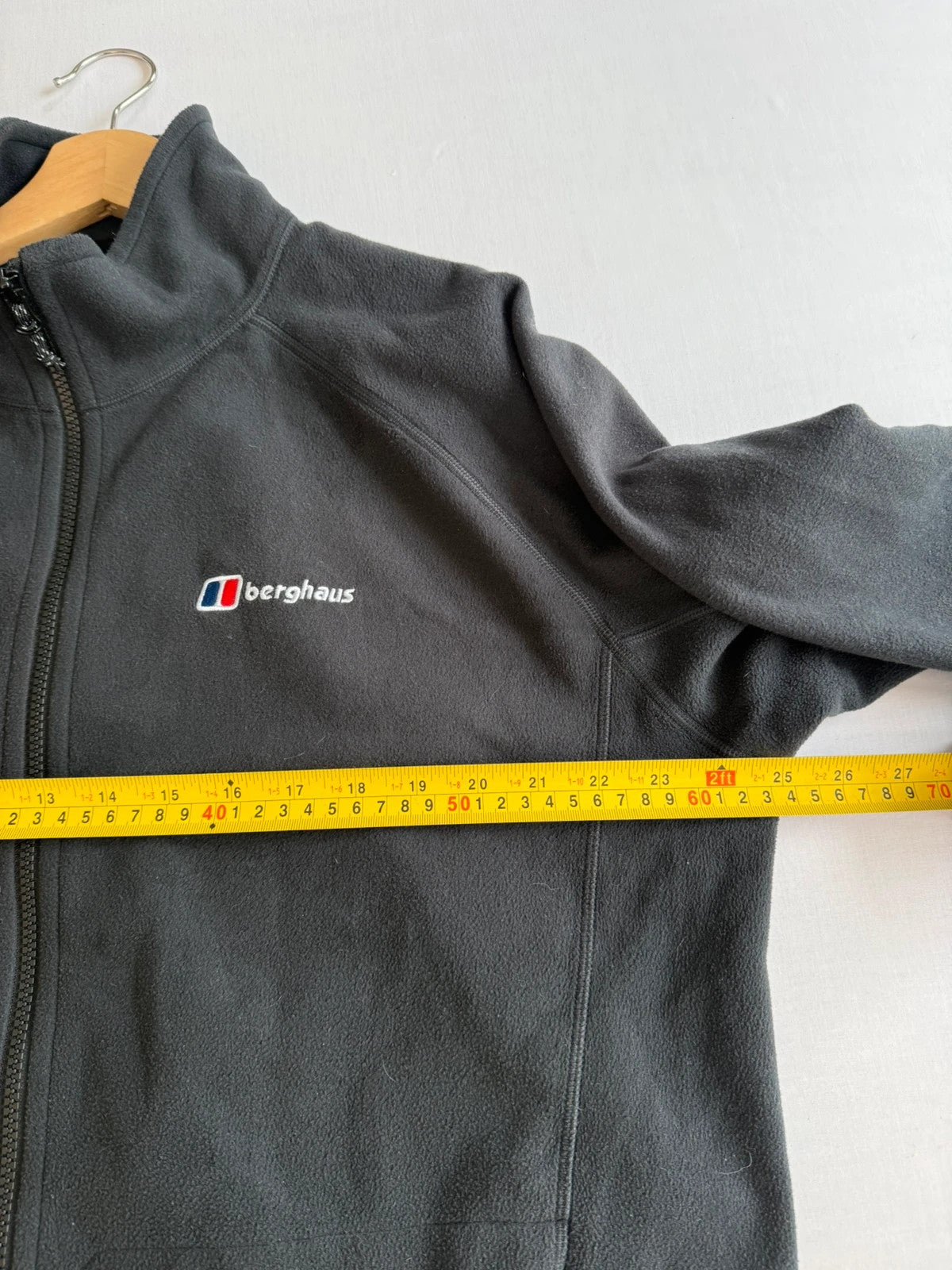 Berghaus grey fleece jacket with stand-up collar and zipped pockets, lightweight polyester.