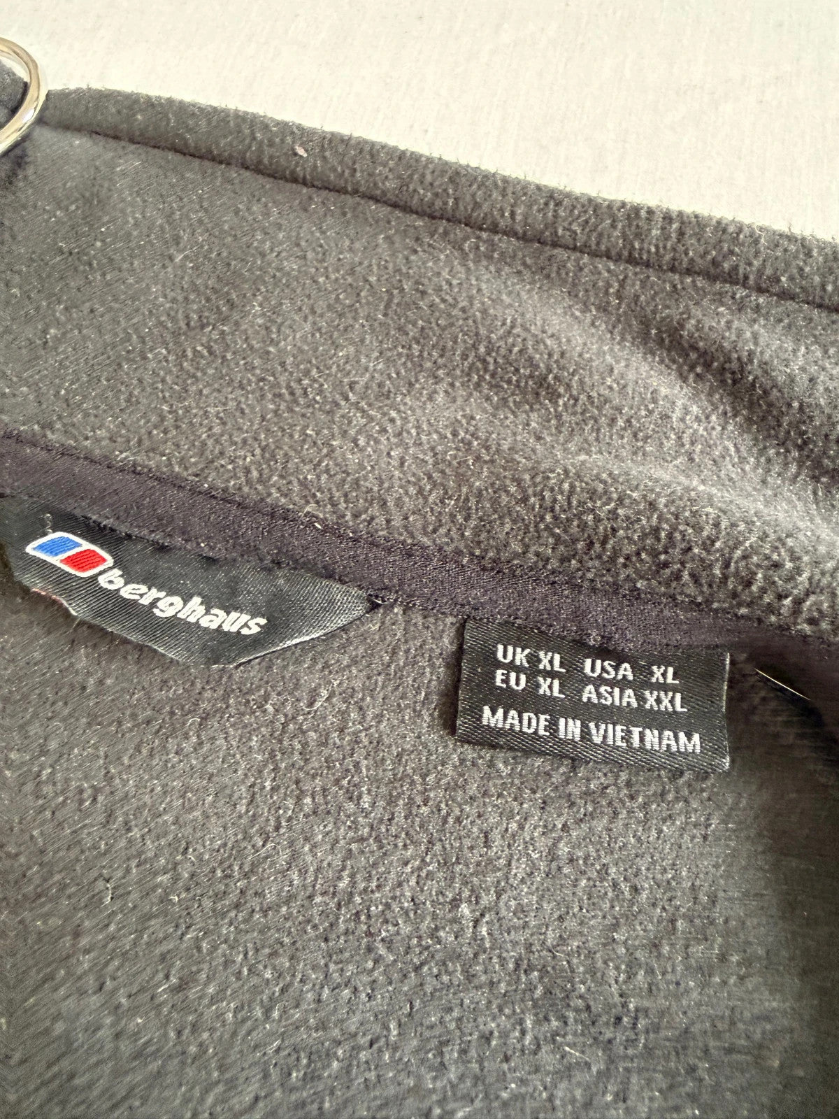 Berghaus grey fleece jacket with stand-up collar and zipped pockets, lightweight polyester.