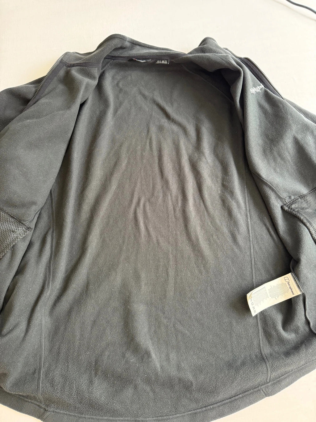 Berghaus grey fleece jacket with stand-up collar and zipped pockets, lightweight polyester.