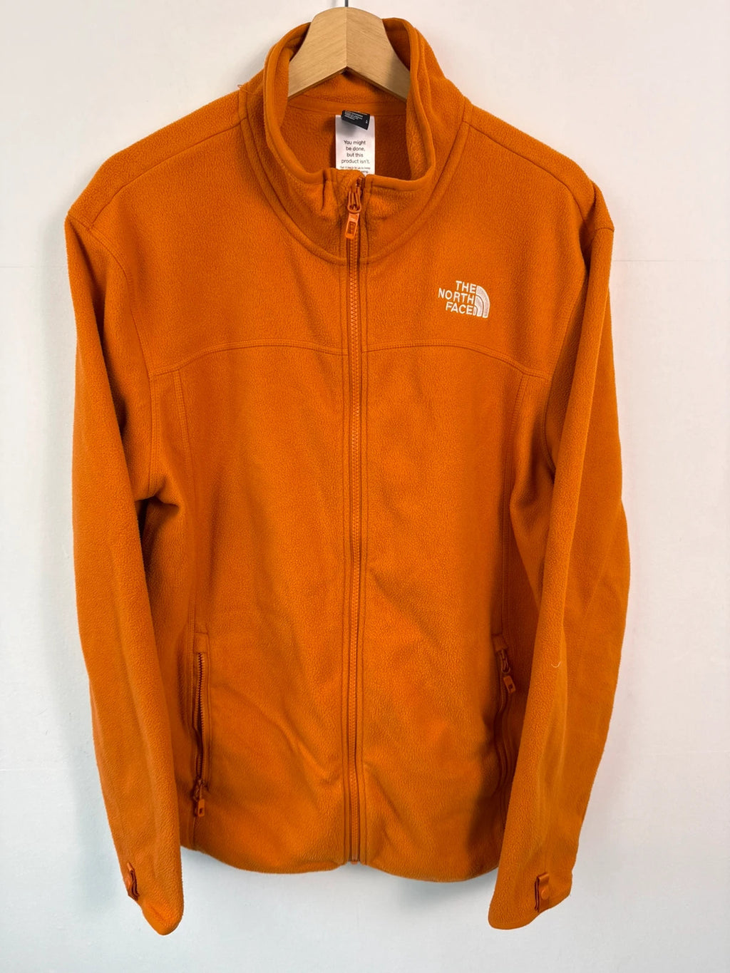 The North Face orange fleece jacket with embroidered logo and high stand collar.