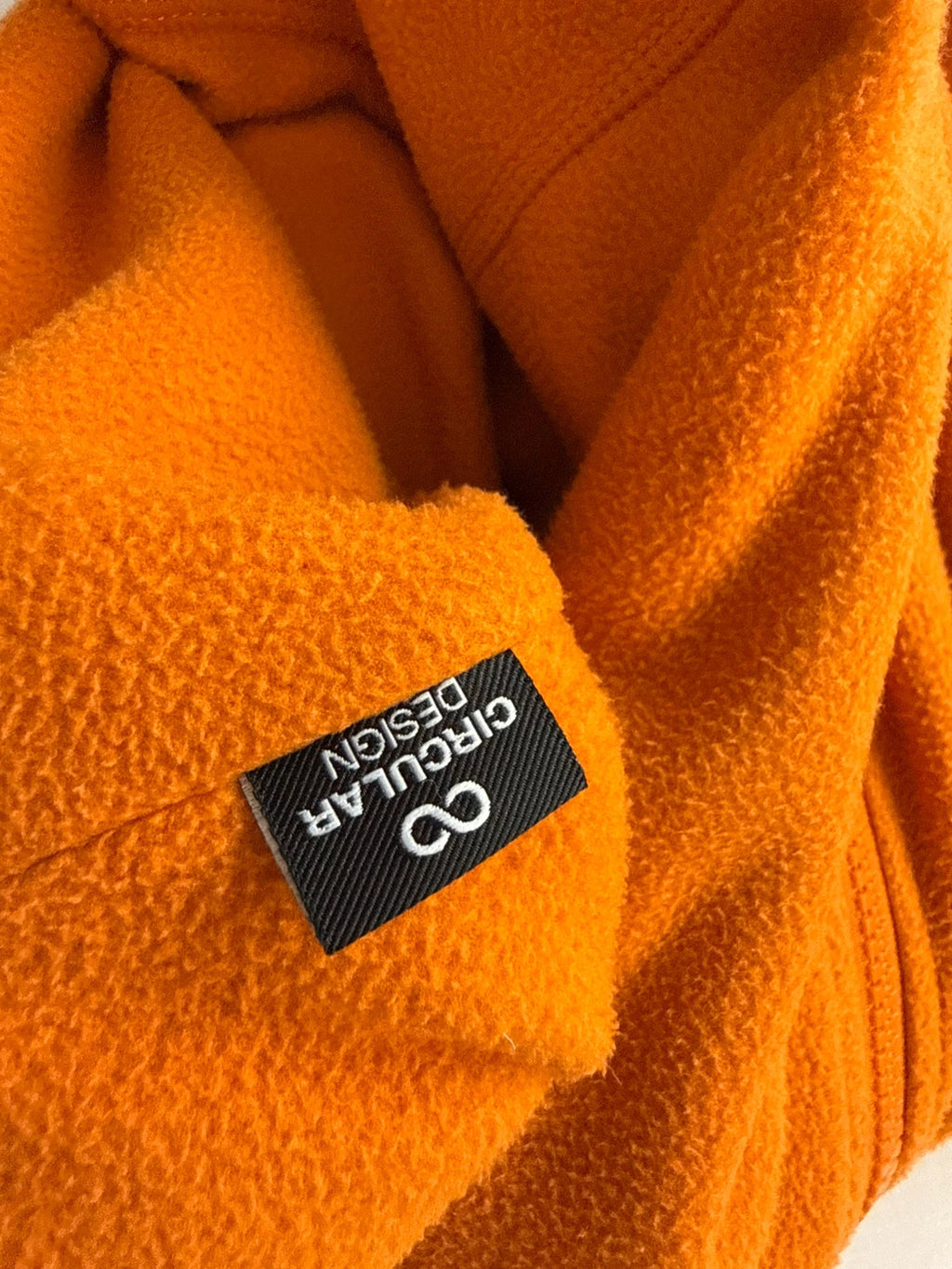 The North Face orange fleece jacket with embroidered logo and high stand collar.