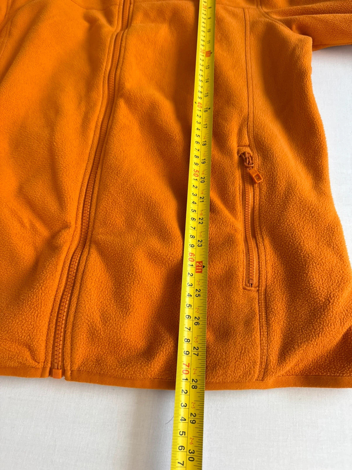 The North Face orange fleece jacket with embroidered logo and high stand collar.