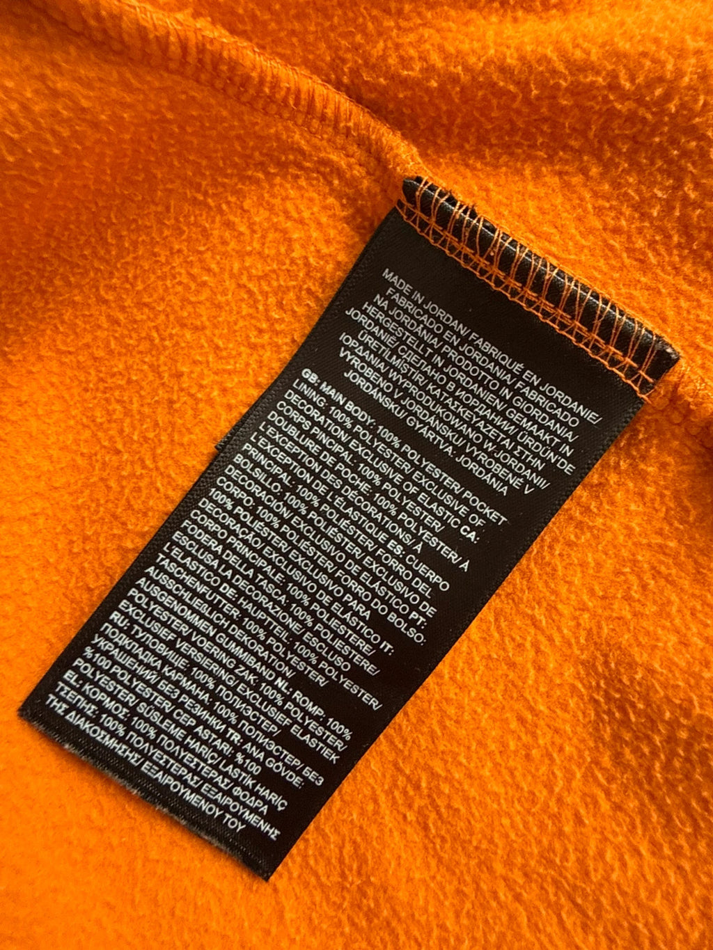 The North Face orange fleece jacket with embroidered logo and high stand collar.
