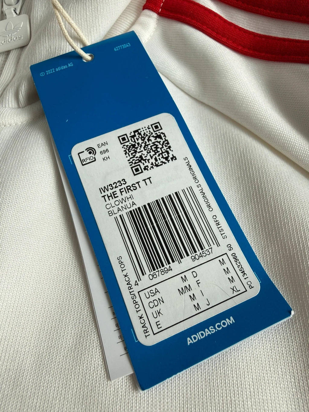 Adidas white track top with red 3-stripes, tonal stripes, full zip, stand-up collar.