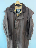 Barbour brown waxed cotton riding coat with corduroy collar and tartan lining.