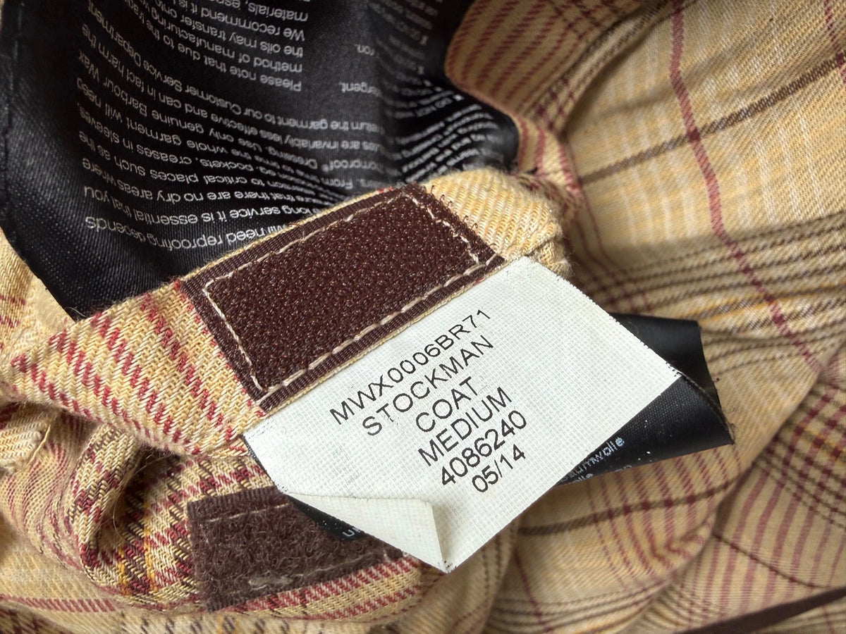Barbour brown waxed cotton riding coat with corduroy collar and tartan lining.