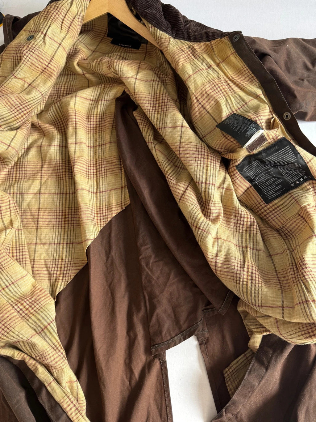 Barbour brown waxed cotton riding coat with corduroy collar and tartan lining.