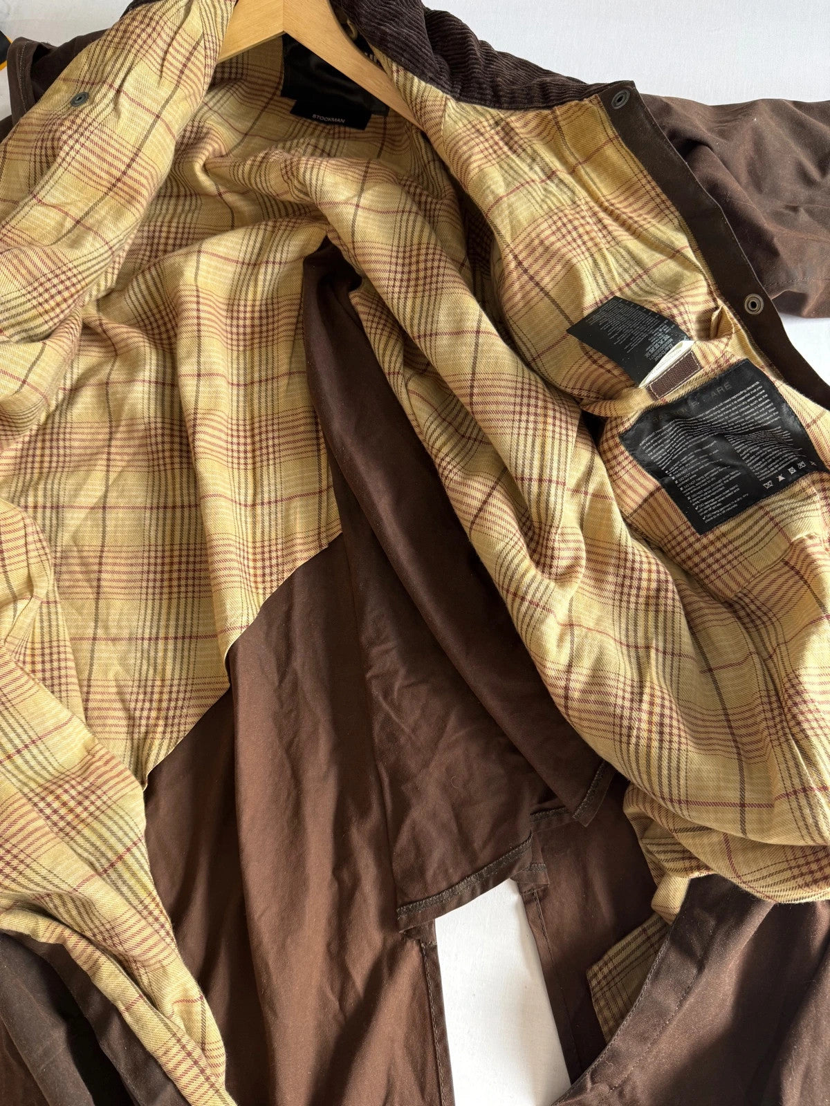 Barbour brown waxed cotton riding coat with corduroy collar and tartan lining.