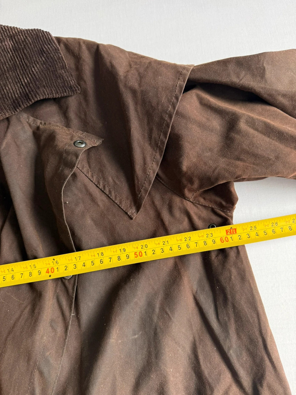 Barbour brown waxed cotton riding coat with corduroy collar and tartan lining.