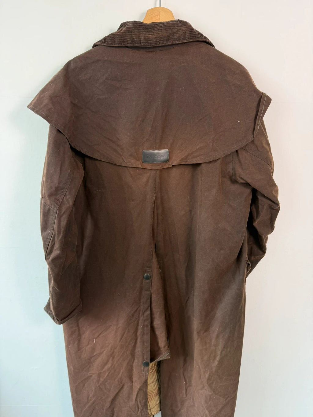 Barbour brown waxed cotton riding coat with corduroy collar and tartan lining.