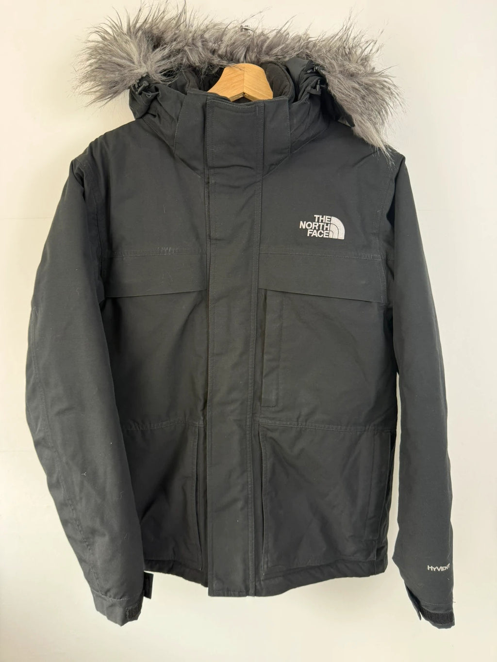 The North Face black parka with detachable faux fur hood and waterproof HyVent technology.