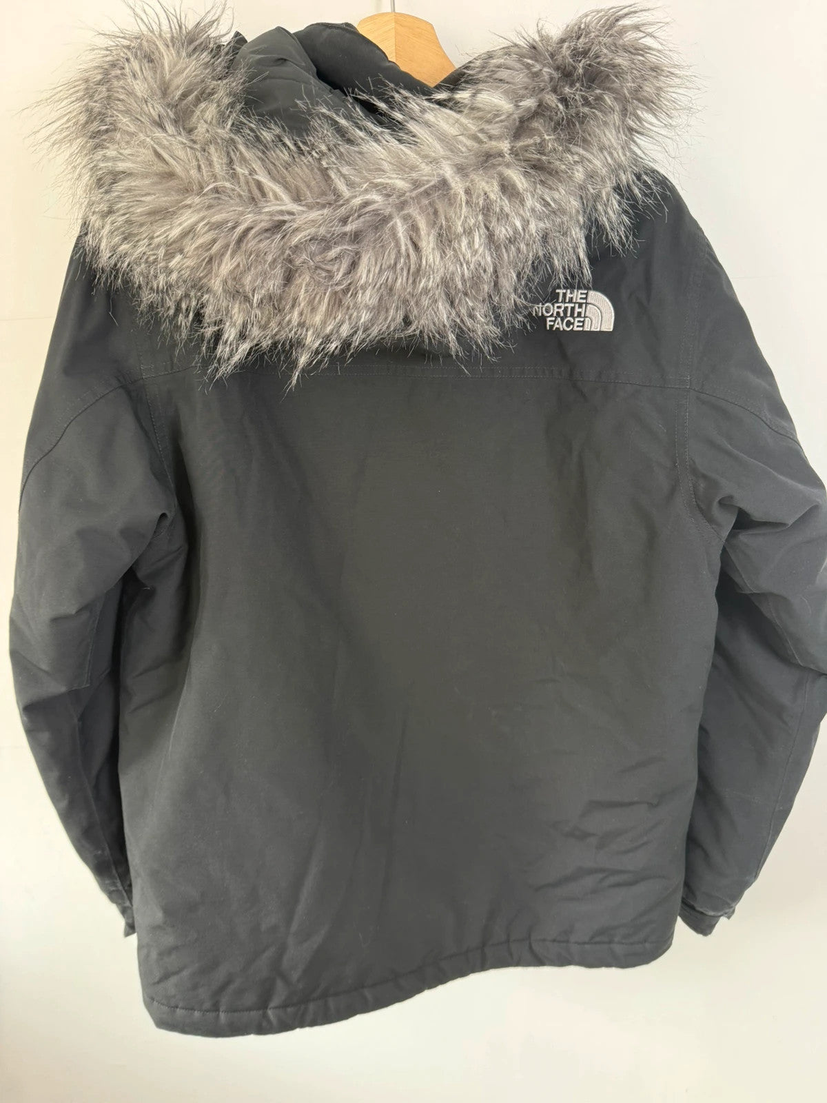 The North Face black parka with detachable faux fur hood and waterproof HyVent technology.
