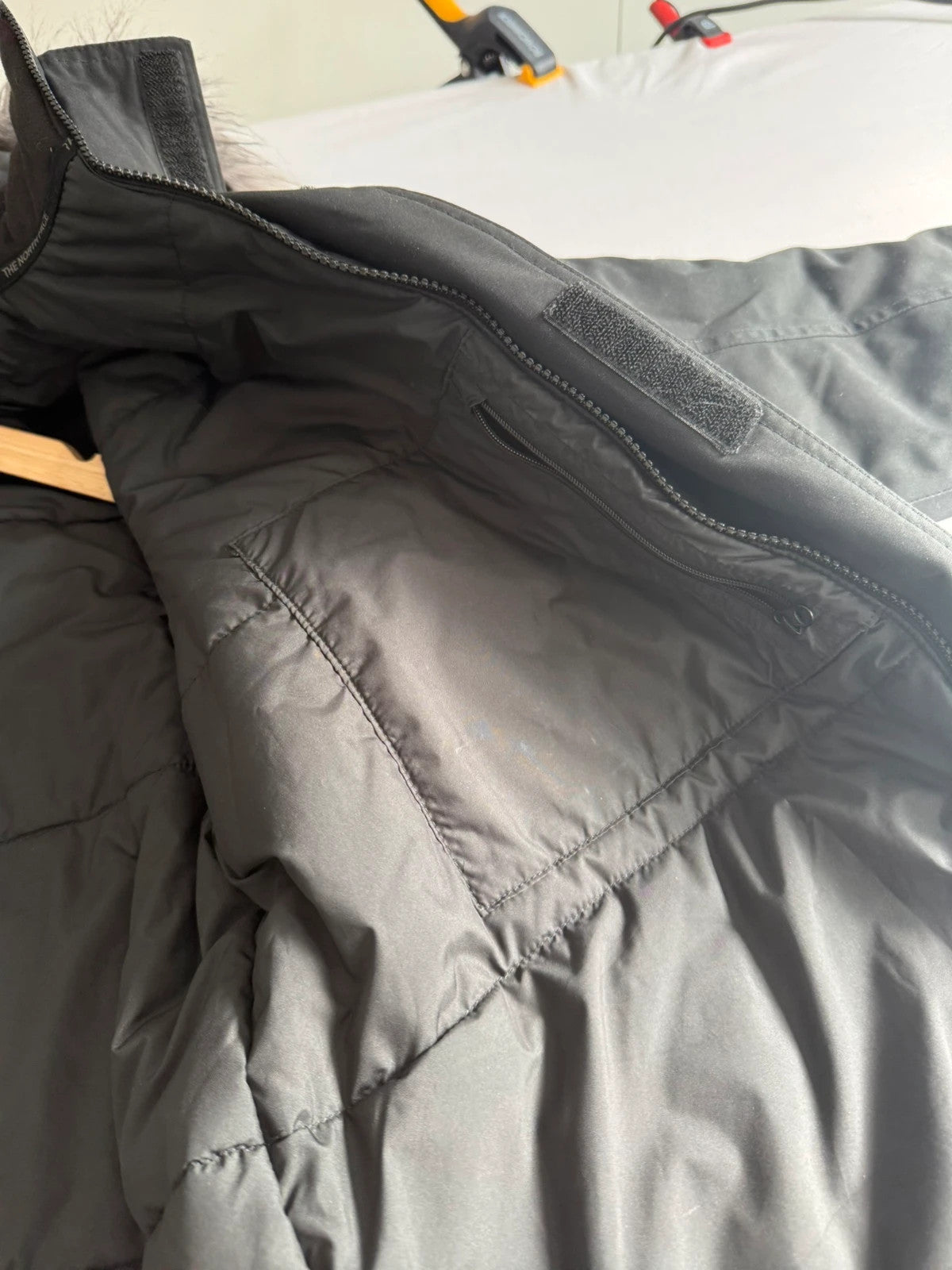 The North Face black parka with detachable faux fur hood and waterproof HyVent technology.
