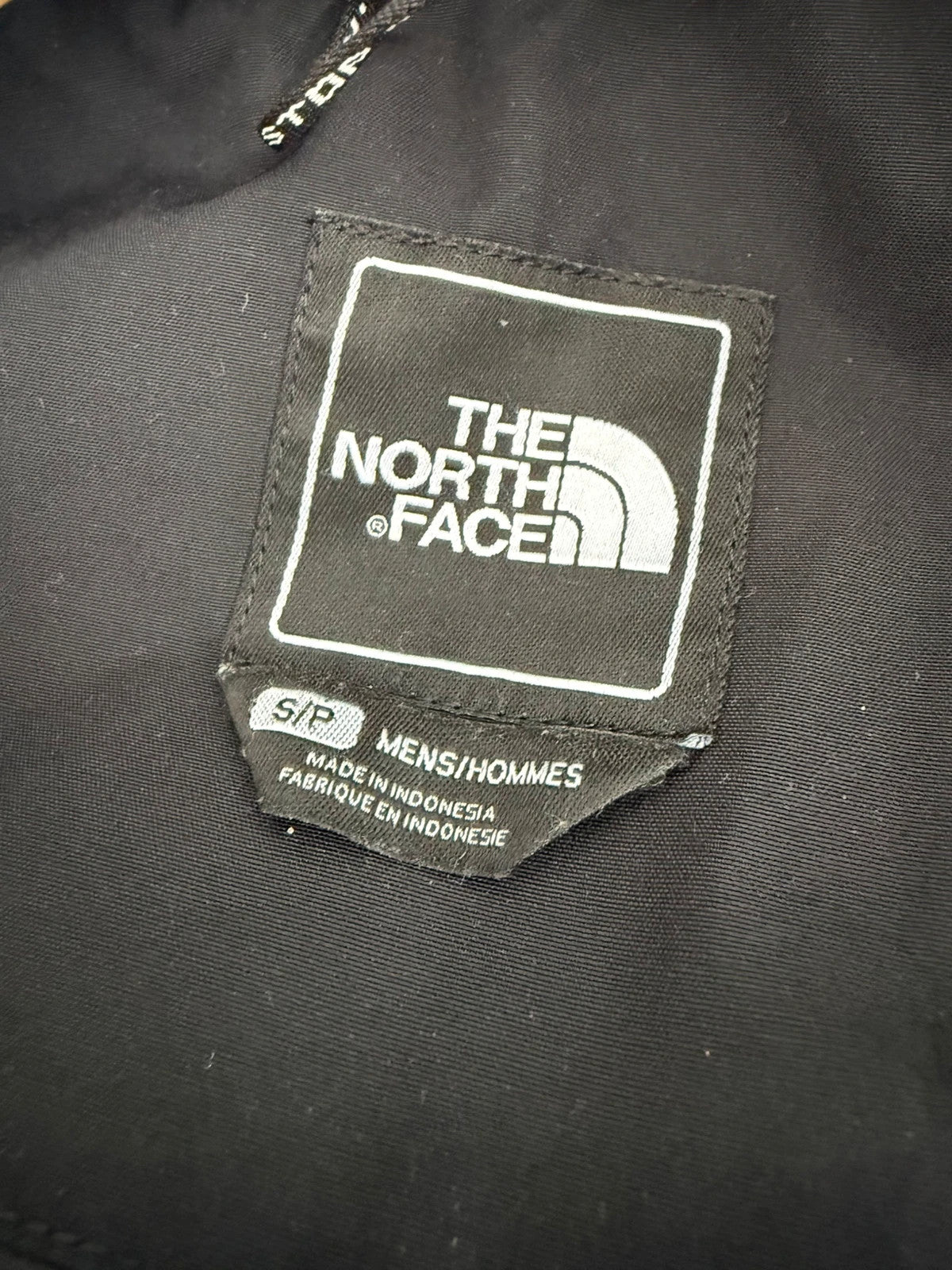 The North Face black parka with detachable faux fur hood and waterproof HyVent technology.