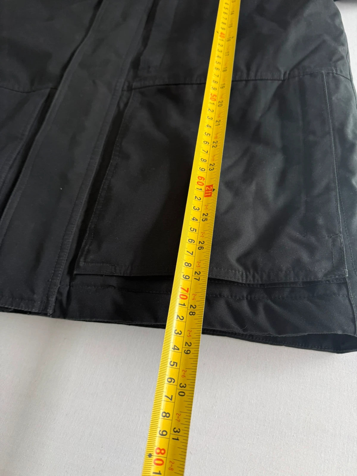 The North Face black parka with detachable faux fur hood and waterproof HyVent technology.