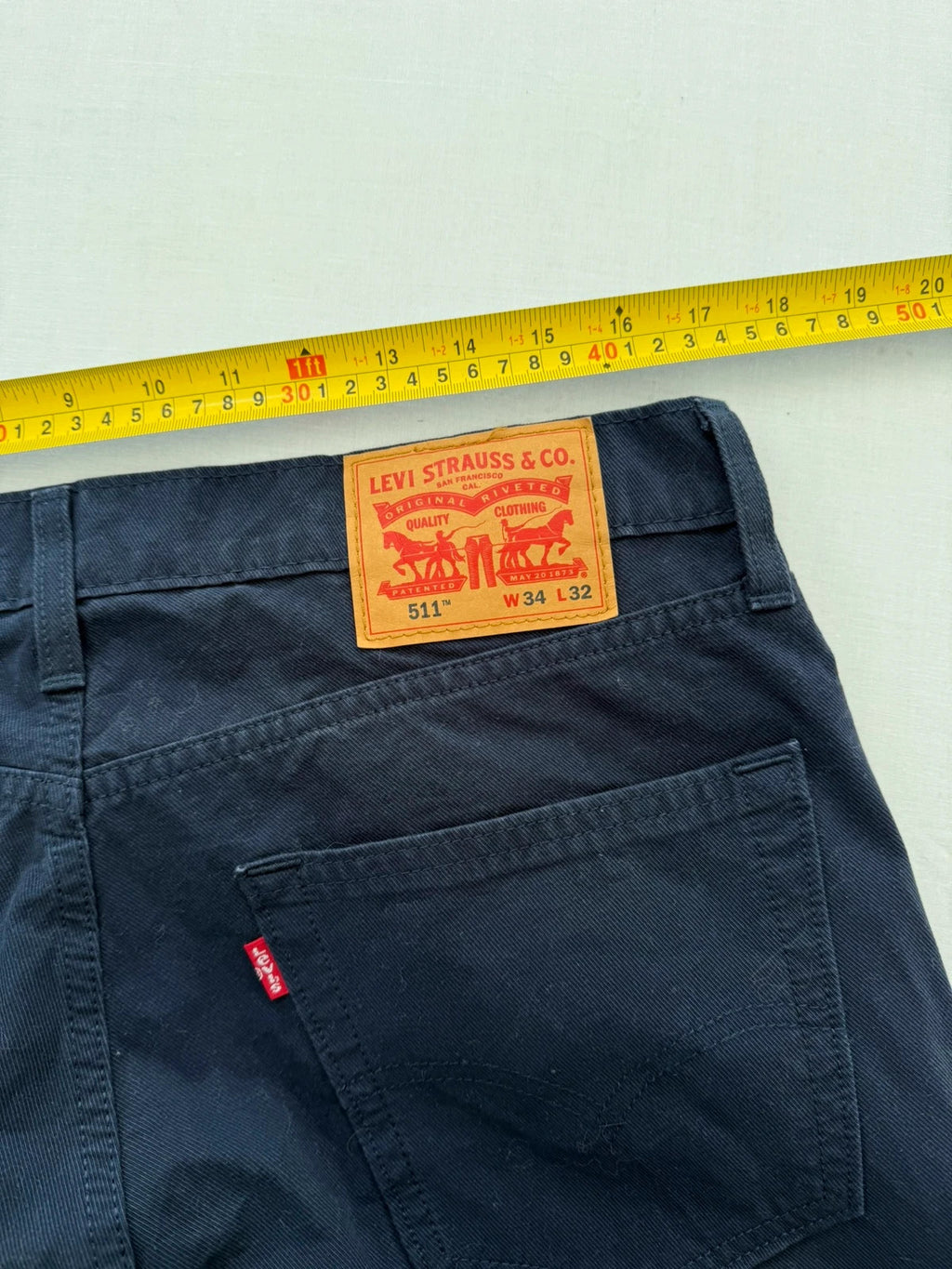 Levi's navy straight jeans with red tab logo and stretch cotton denim.