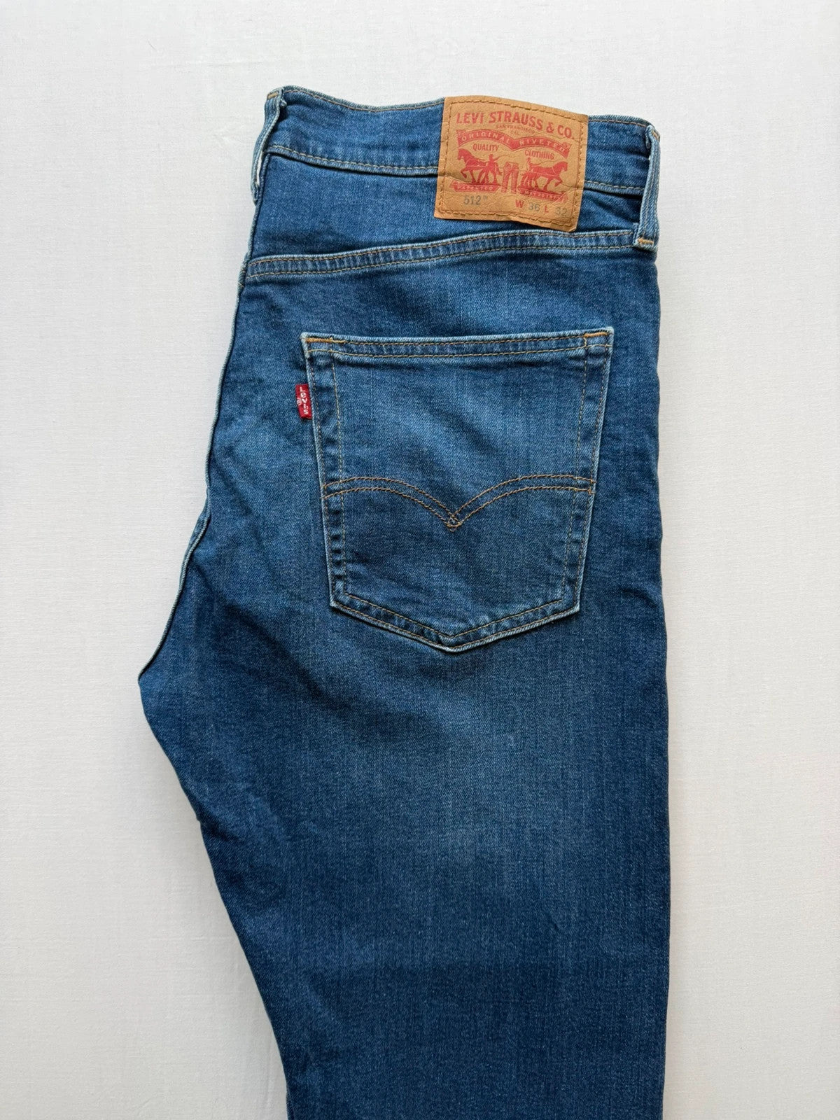 Levi's blue slim tapered jeans with classic five-pocket styling in medium wash.