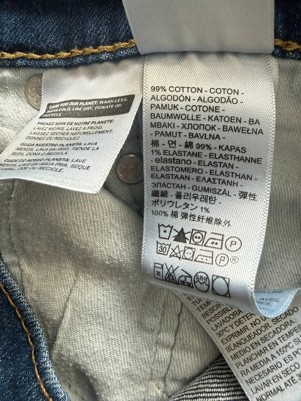 Levi's blue slim tapered jeans with classic five-pocket styling in medium wash.