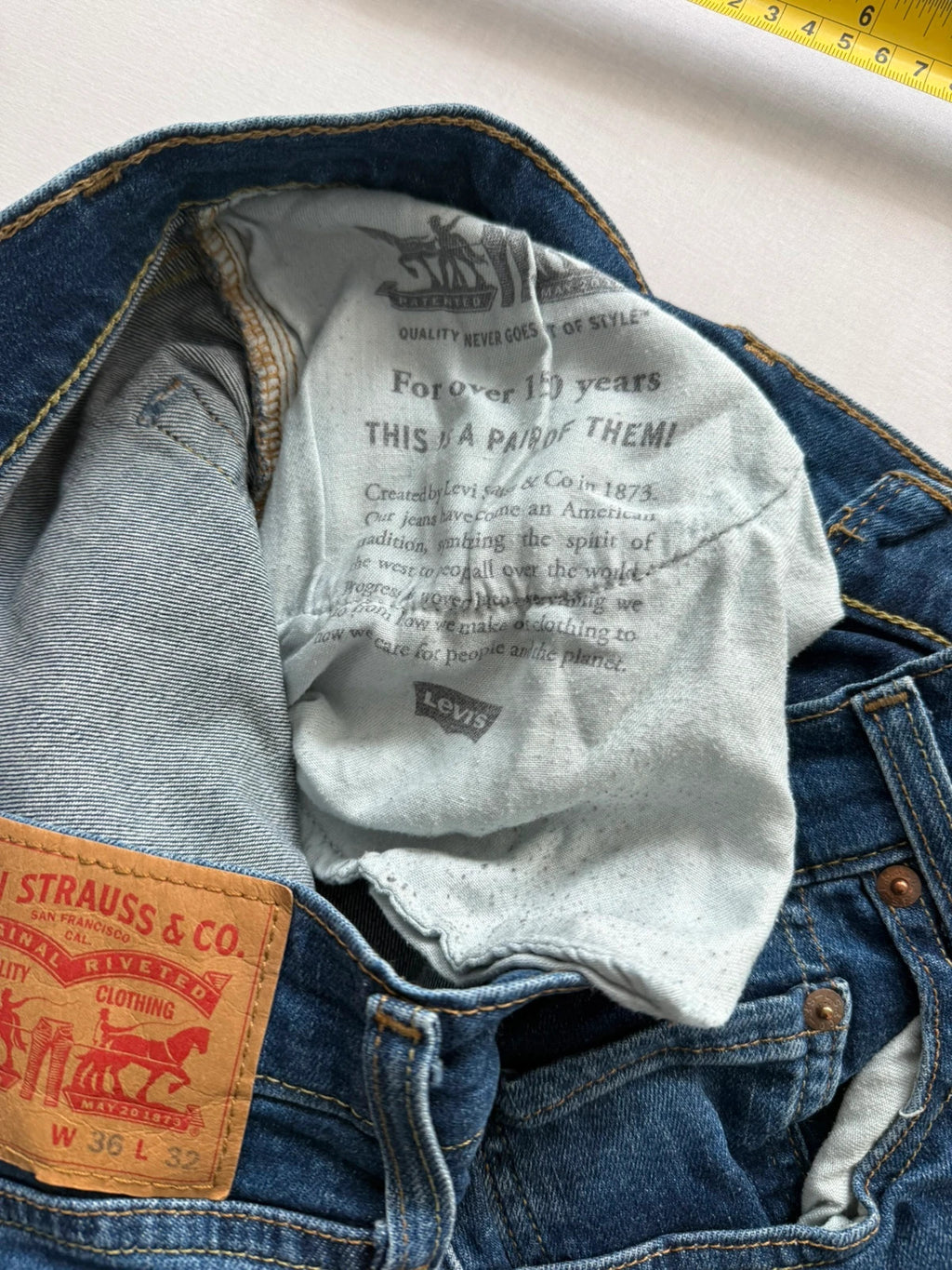 Levi's blue slim tapered jeans with classic five-pocket styling in medium wash.