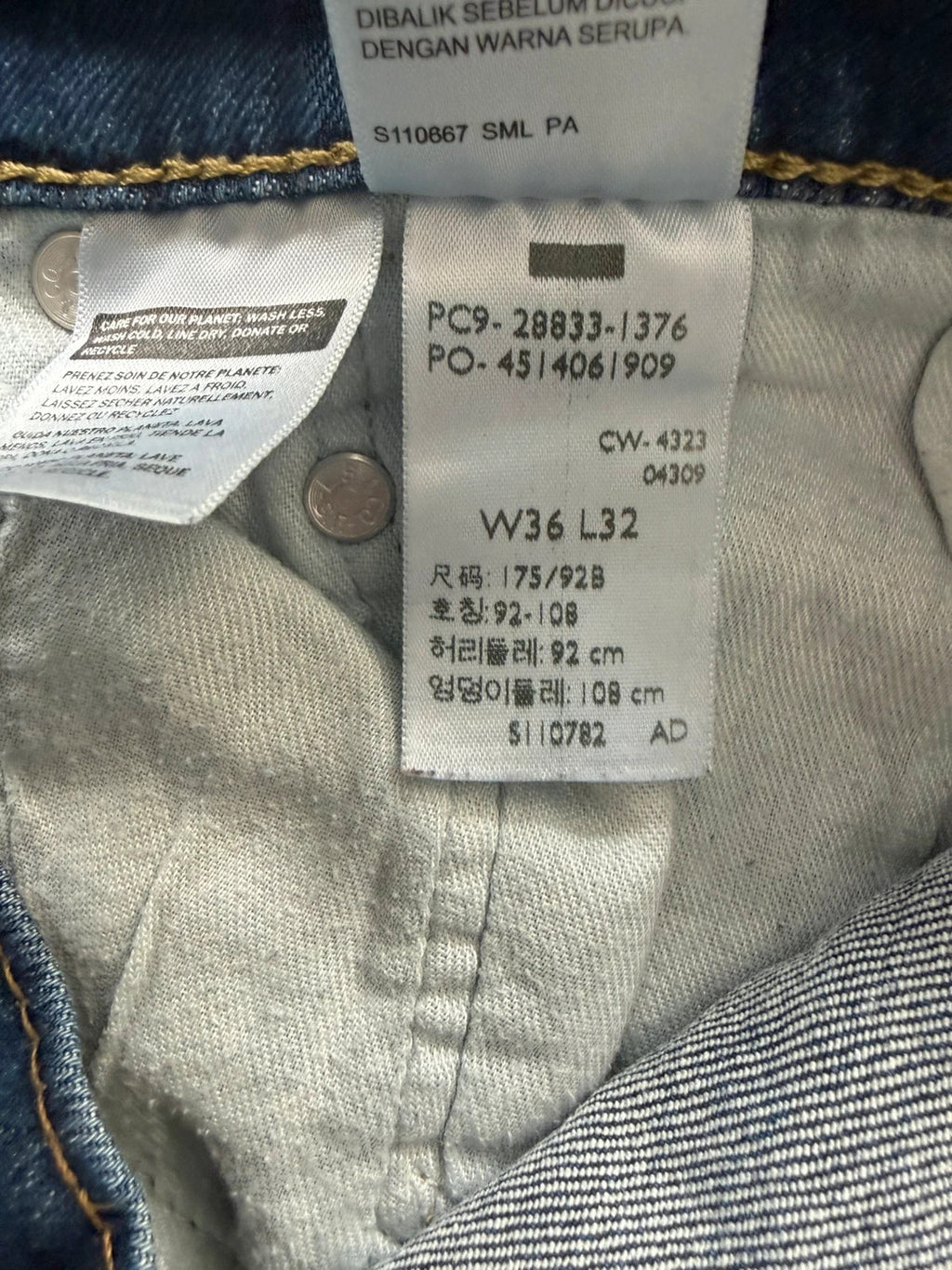 Levi's blue slim tapered jeans with classic five-pocket styling in medium wash.