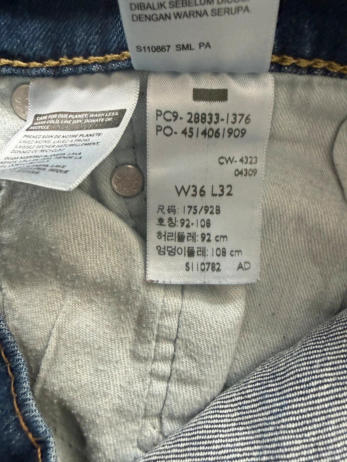 Levi's blue slim tapered jeans with classic five-pocket styling in medium wash.