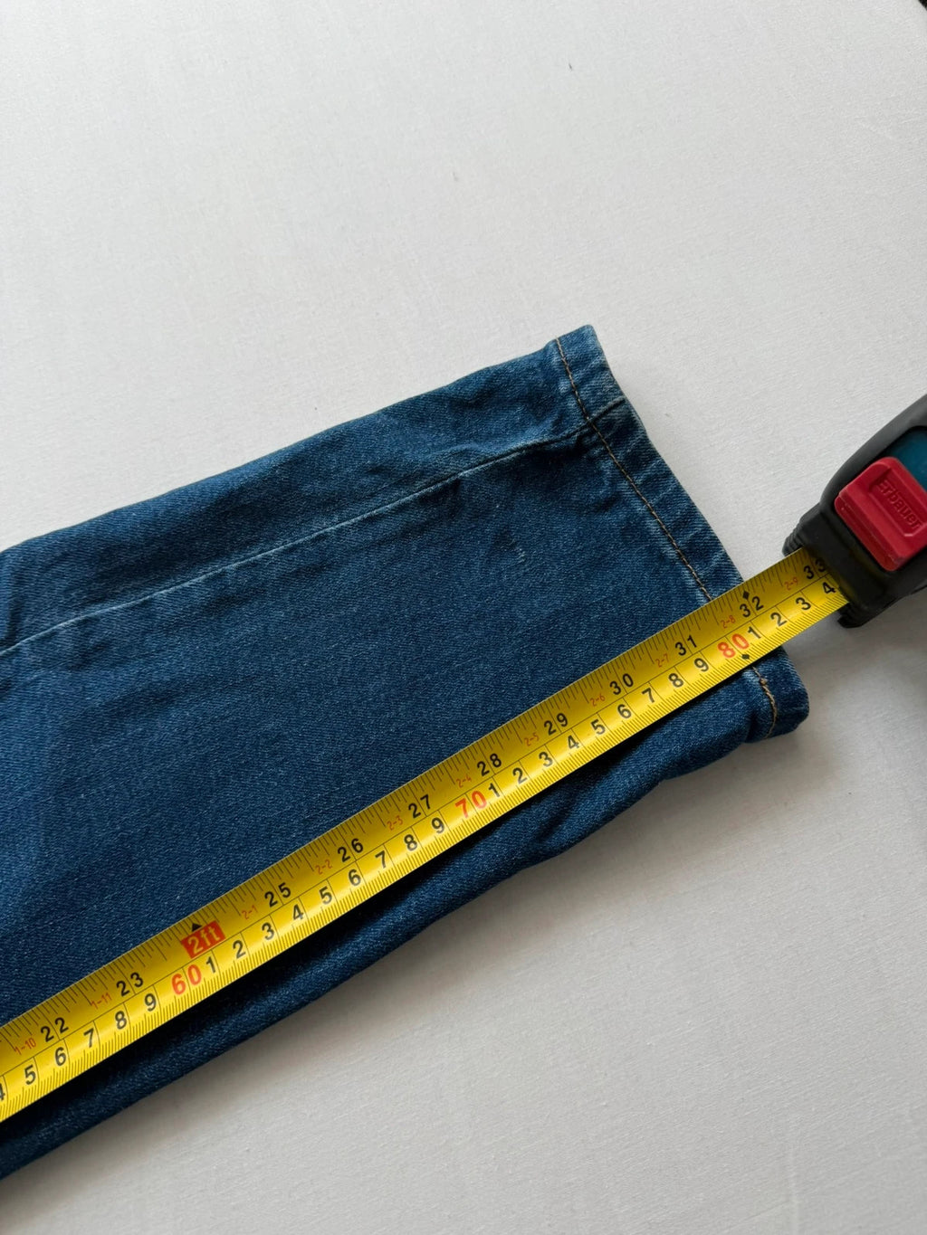 Levi's blue slim tapered jeans with classic five-pocket styling in medium wash.